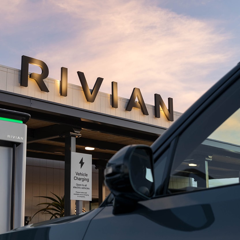 A Rivian electric vehicle parked in front of the Rivian Joshua Tree charging outpost