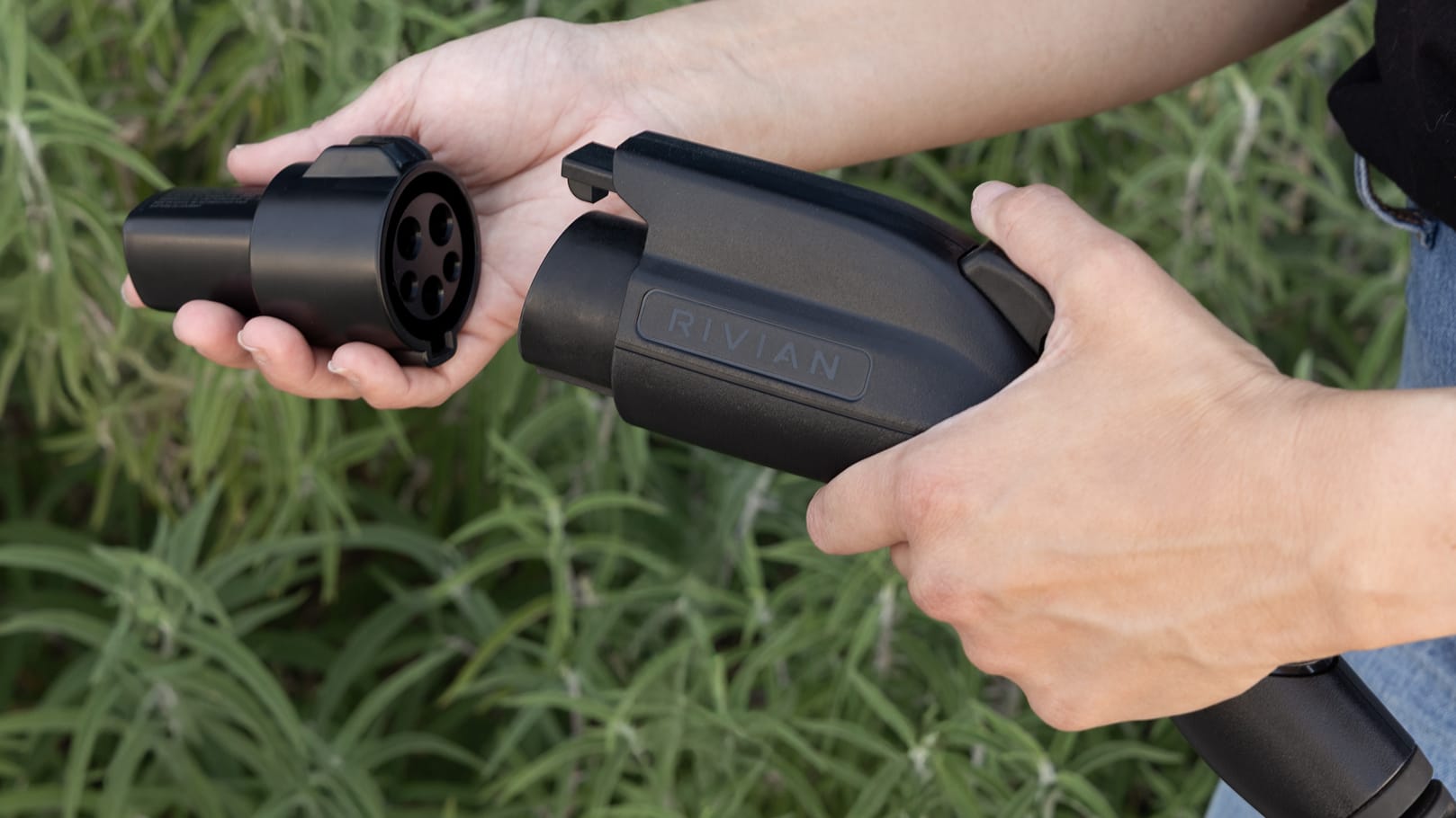 Person holds a charging port with an adapter.