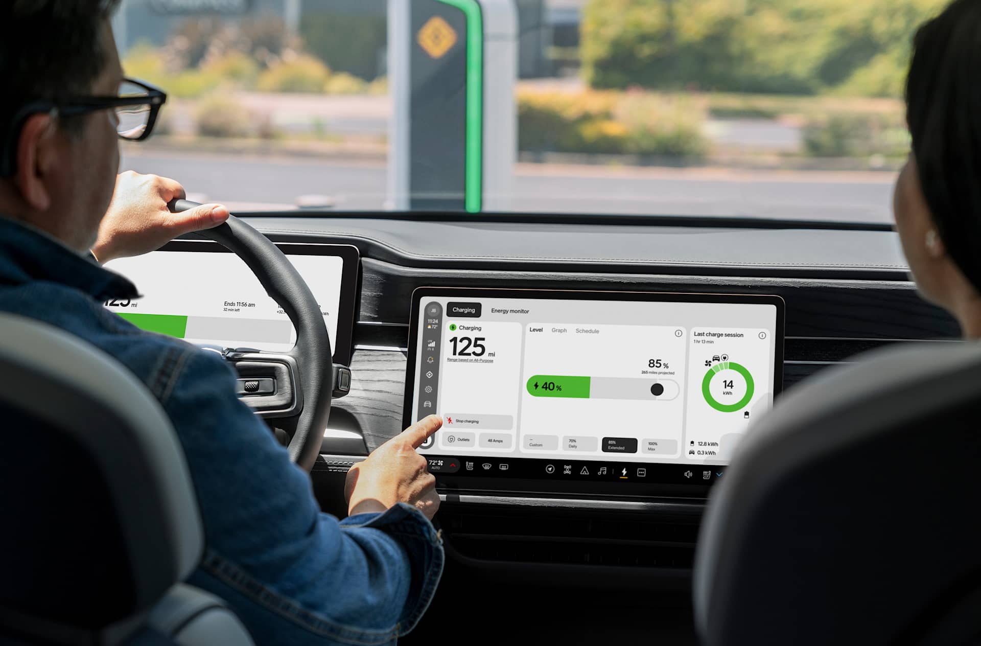 Woman with red nails taps a Rivian's infotainment display to view her charging session and range.