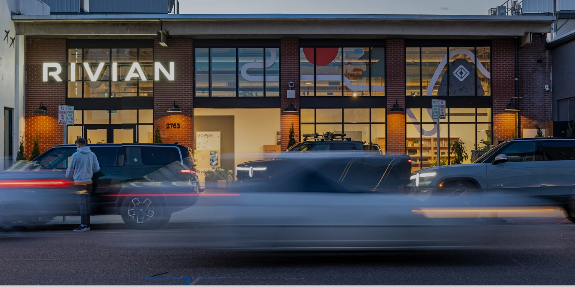 Rivian vehicles parked in front of Rivian Denver space