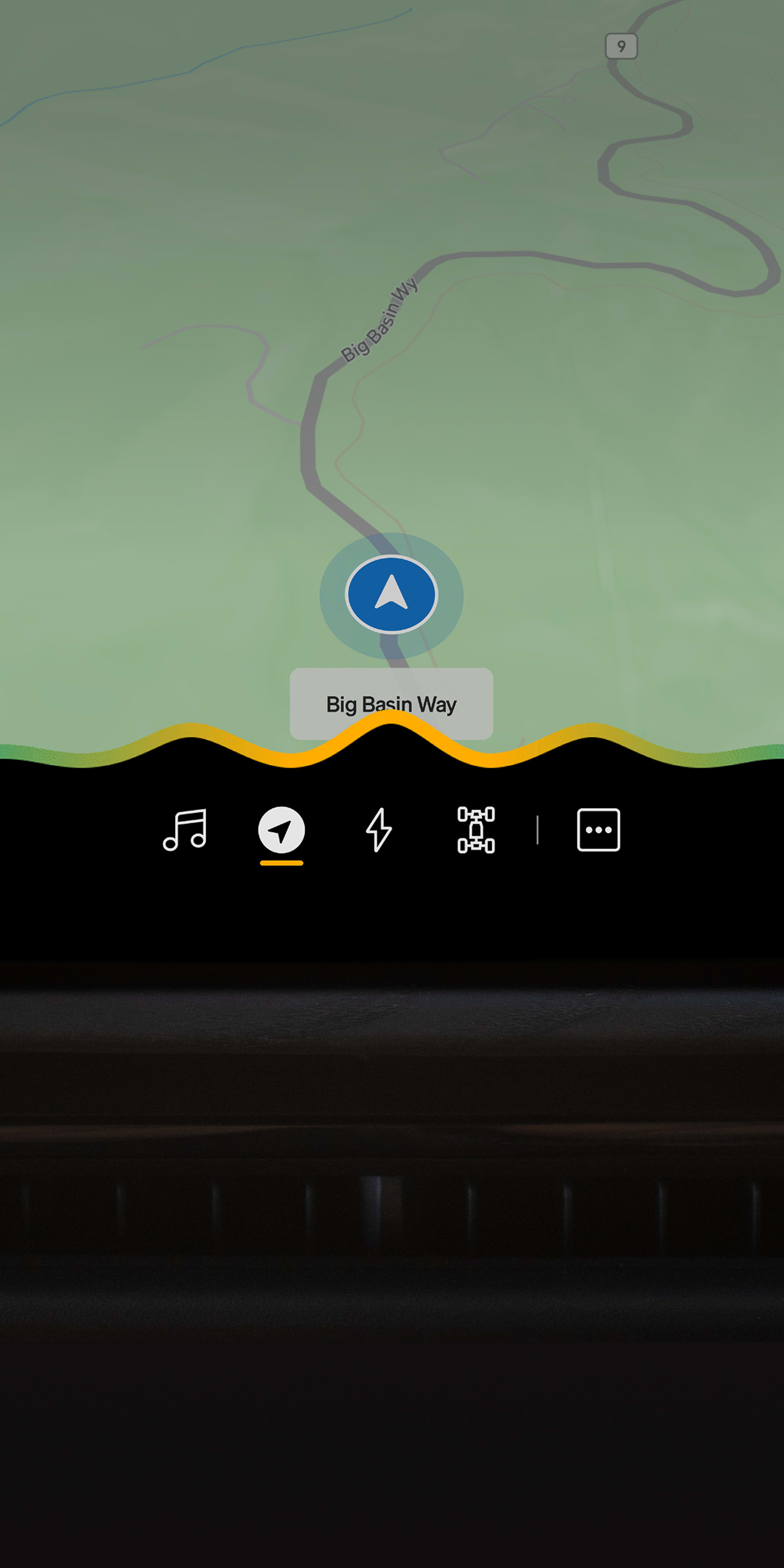 Driver uses Rivian Assistant on the center display to send a drafted arrival update while navigating on Big Basin Way. 