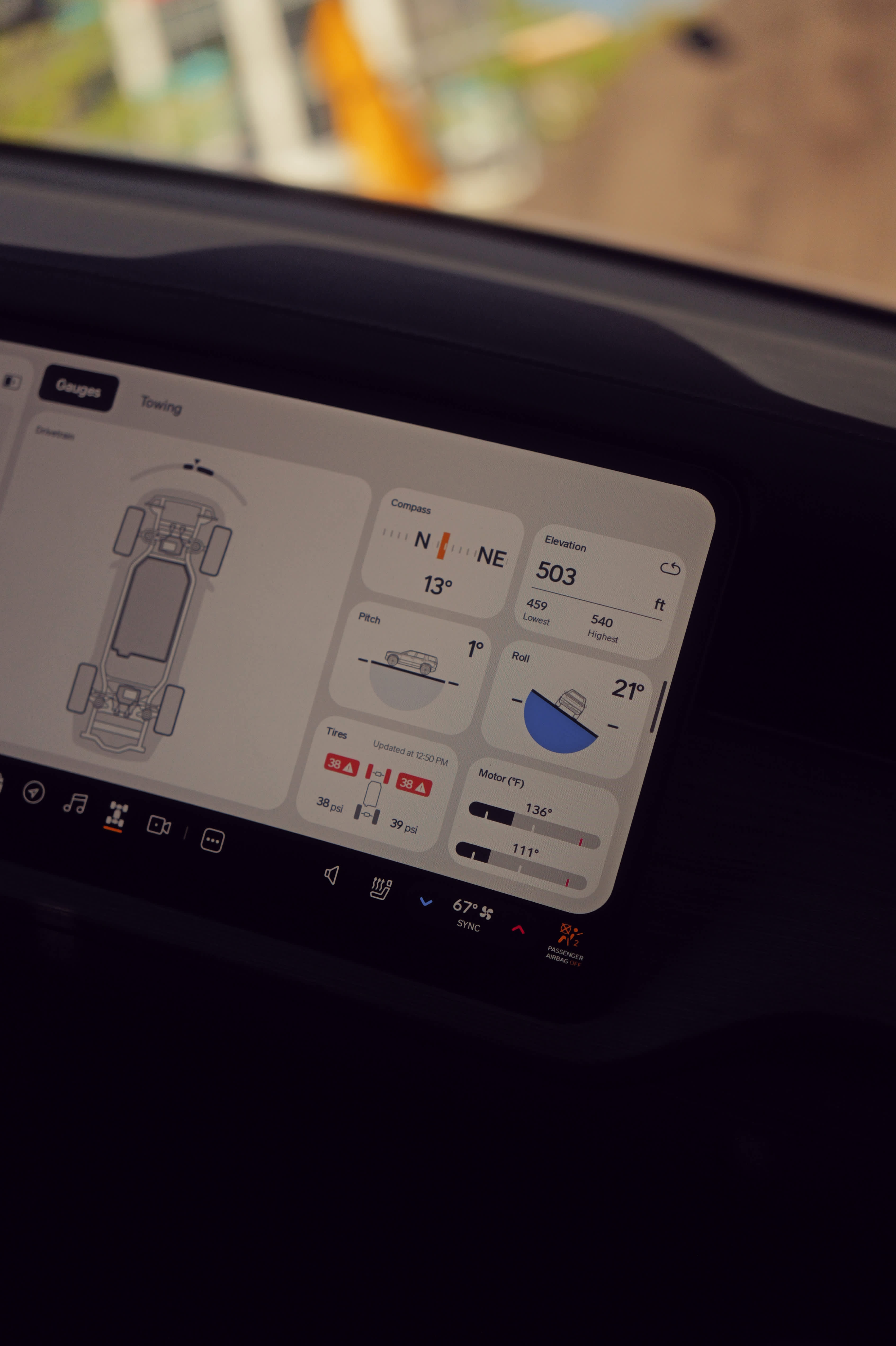 The Rivian R2 infotainment system showing off-road gauges, including pitch, roll, and motor temperature, during SXSW 2026.