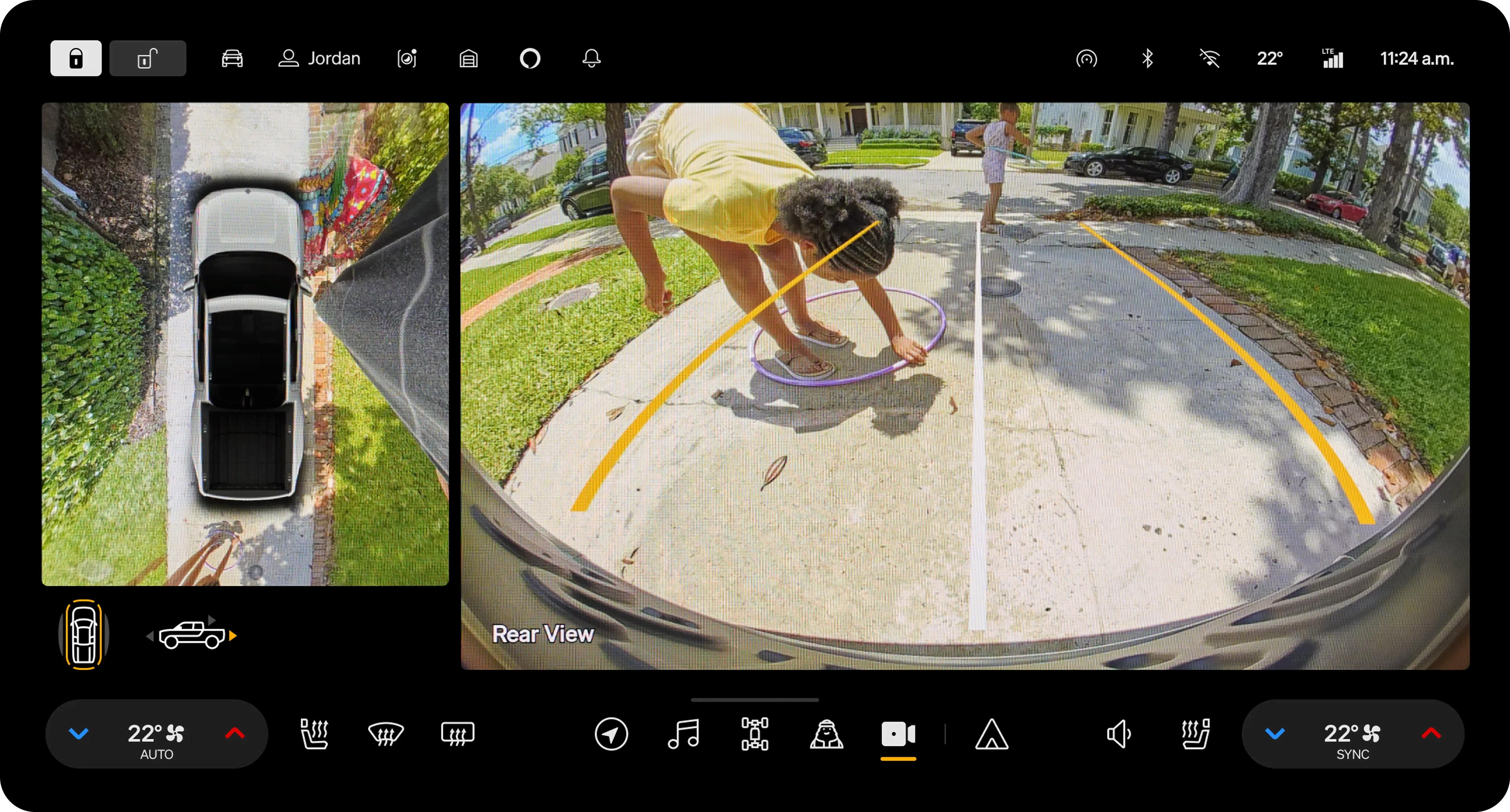 Vehicle's enter display shows a top-down (Bird’s Eye) view and rear camera.