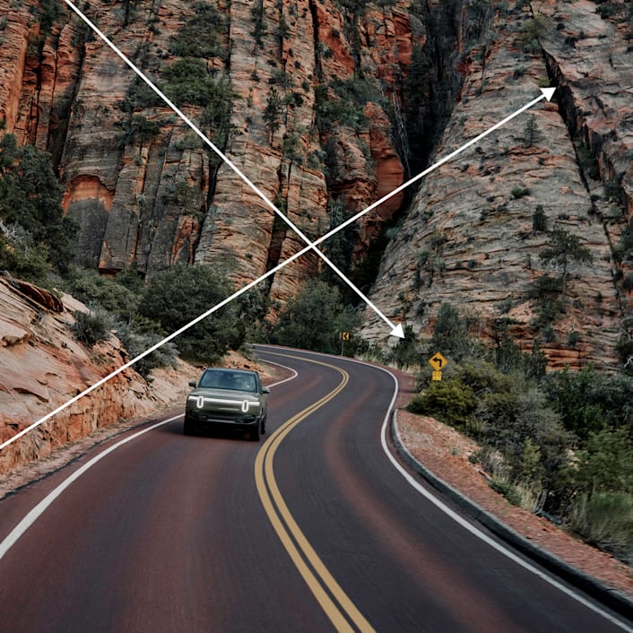 L'avant d'un véhicule électrique à quatre moteurs Rivian R1 de la couleur Vert fougère en édition limitée. L'image met en lumière les phares distinctifs de Rivian.
