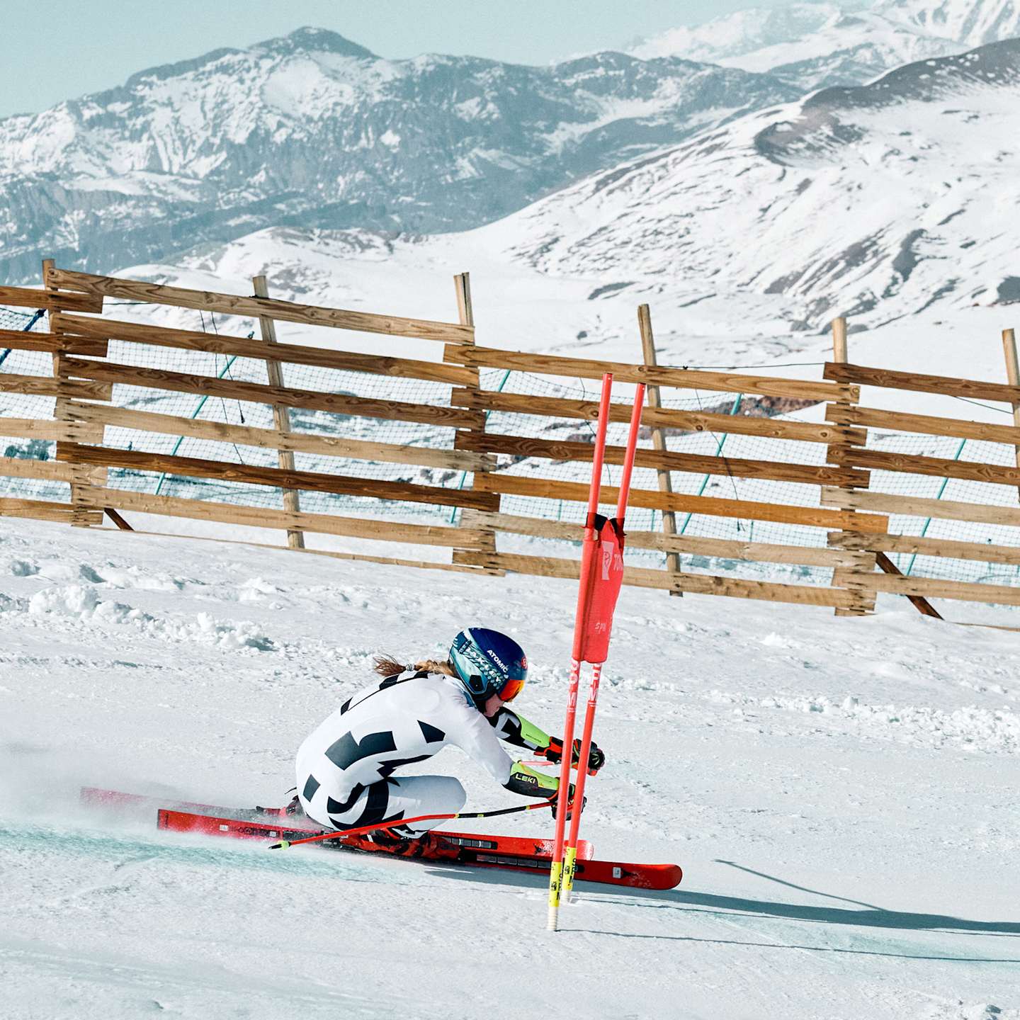 Action shot of Mikaela Shiffrin skiing in competition down a snowy mountain.