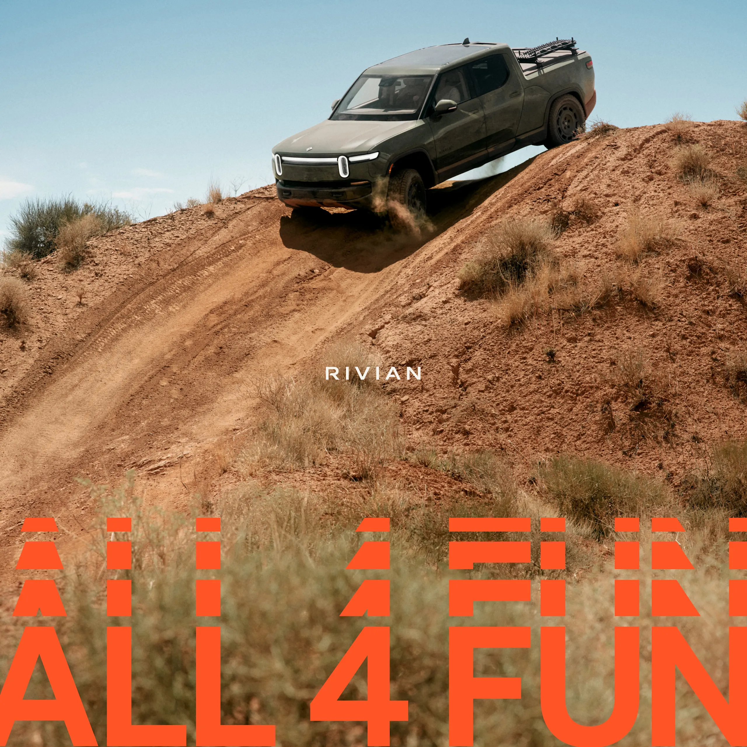 A Rivian R1T electric vehicle partially mid-air as it drives over the peak of a steep dirt hill. The car features the limited edition Launch Green paint color. The bottom of the picture says "All 4 FUN" in orange text.