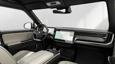 2025 R1S Sandstone + Dark Ash Wood driver seat view