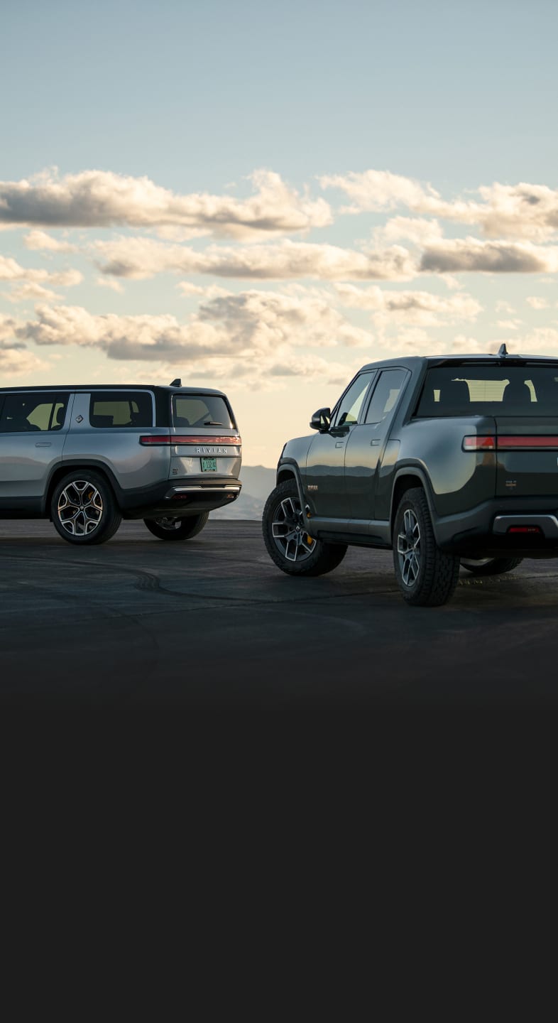 a Red Rivian R1S next to a Blue Rivian R1T